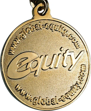 Gold-tone die struck metal example with raised lettering, photo from lapelpin.com.au
